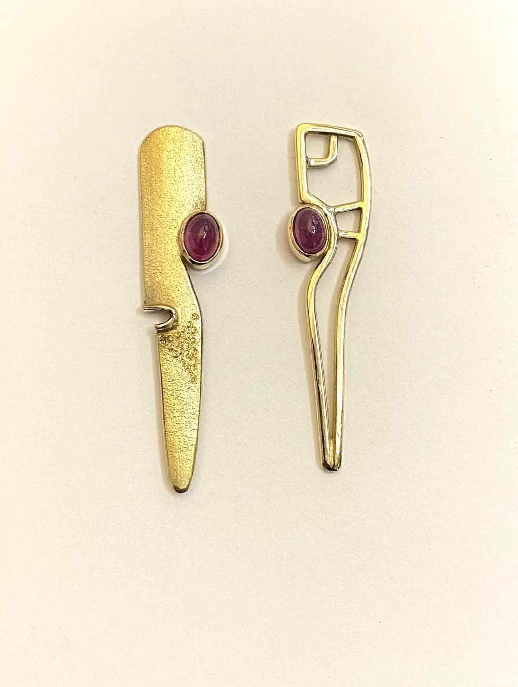 Gold earrings with a pink stone