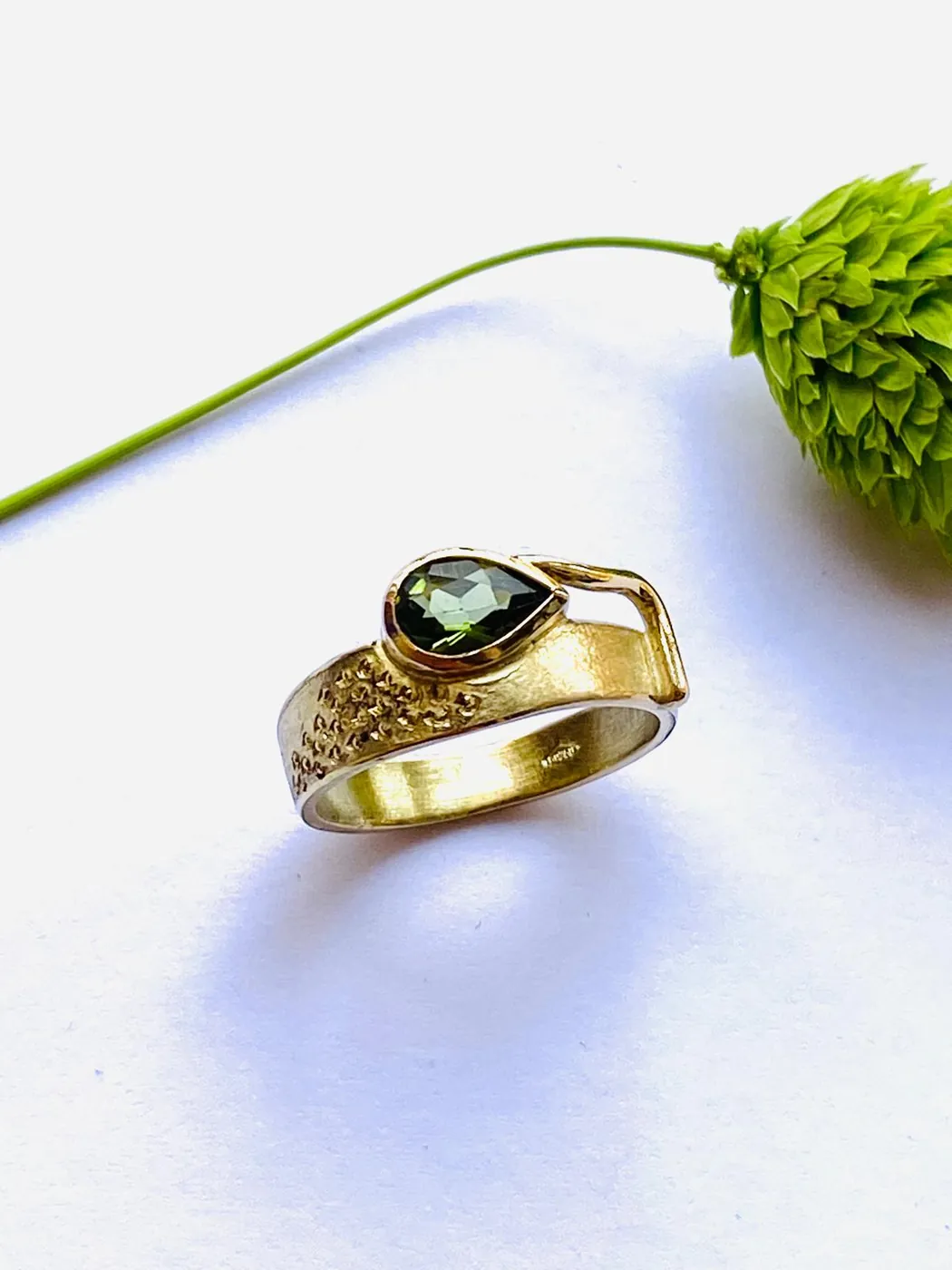 Gold ring with a green stone