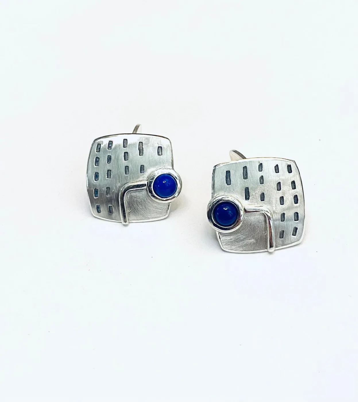 Silver cufflinks with a blue stone