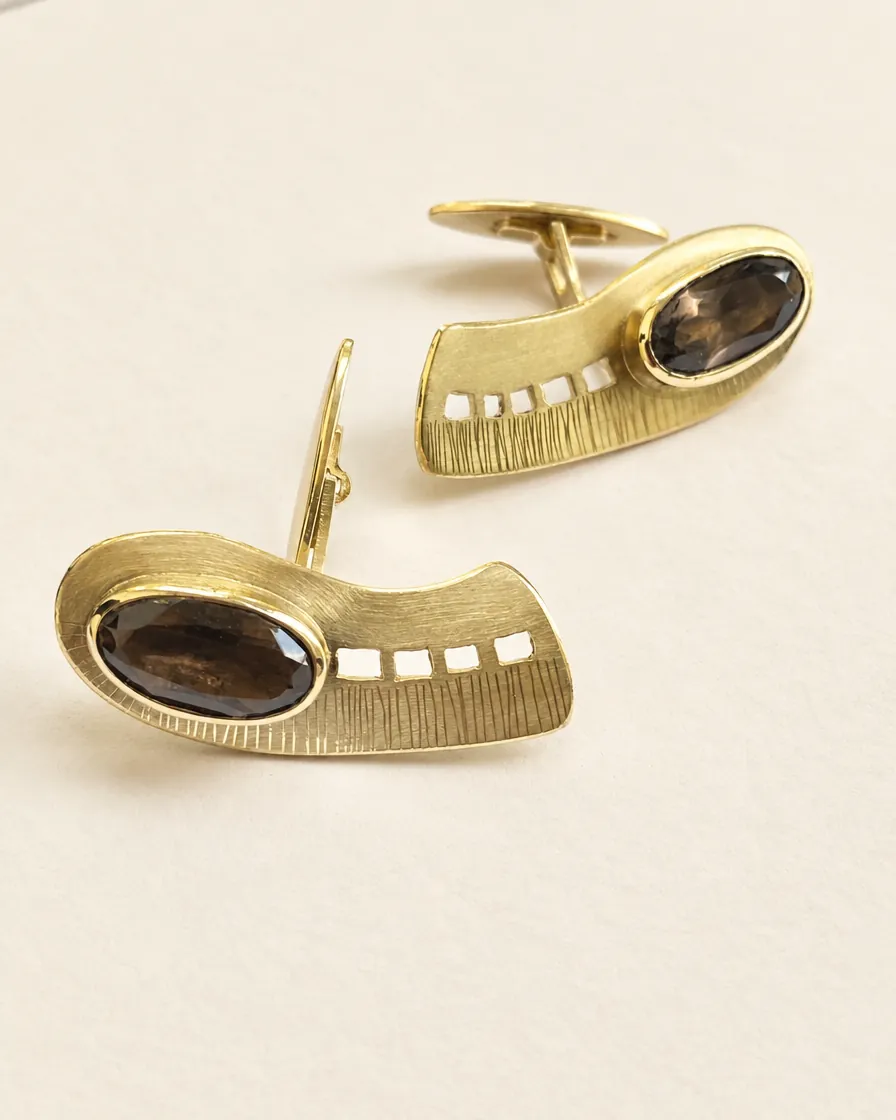 Gold cufflinks with a stone